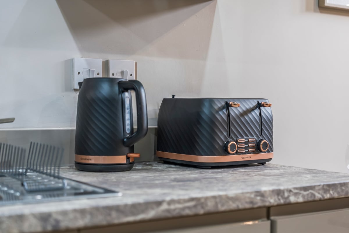 Black kettle and toaster with rose gold trim on the kitchen counter at Athenaeum House
